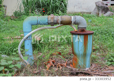 Water valve Plumbing Steel dilapidated on grass 33303952