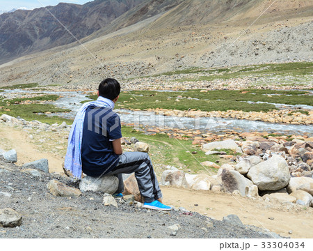 Tourist looking at mountain scenery Tourist looking at mountain scenery 33304034