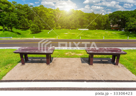 Two chair sitting empty on green grass 33306423