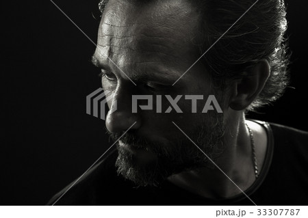 Monochrome portrait of strong man turnig face to 33307787