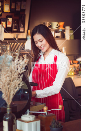 Female Barista wear red apron strips with smiling 33308771