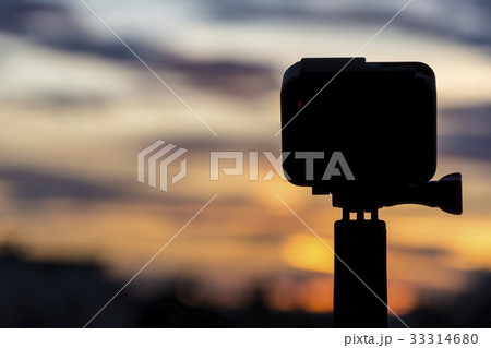 Silhouette Action camera on twilight sky 33314680