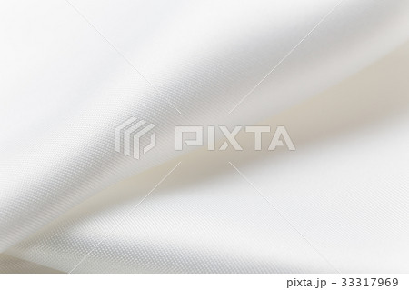 close up of folded shiny white fabric close up of folded shiny white fabric 33317969