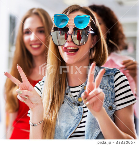 Two girlfriends having fun while doing shopping Two girlfriends having fun while doing shopping 33320657