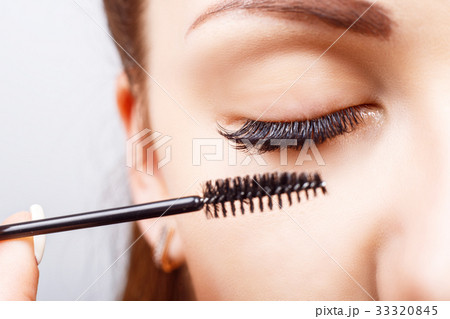 Eyelash Extension Procedure. Woman Eye with Long Eyelash Extension Procedure. Woman Eye with Long 33320845