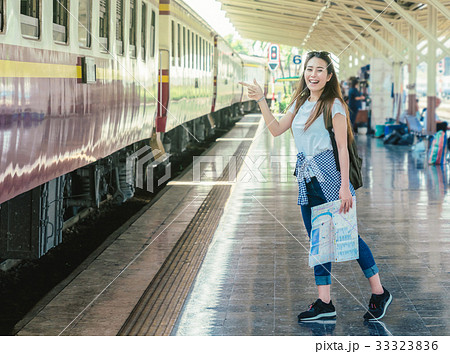 Asia woman Traveller feeling happiness and greeting her friend before go to travel at the train station, Travel and lifestyle concept 33323836
