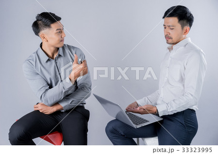 two business men are sitting and discussing something together two business men are sitting and discussing something together 33323995