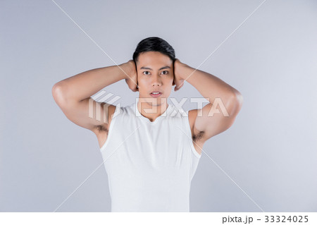 a fitness model is standing with hands behind his head a fitness model is standing with hands behind his head 33324025