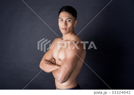a photo of an asian man with his sexy body on black background 33324042
