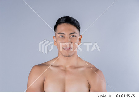 Portrait of an Asian body builder on gray background Portrait of an Asian body builder on gray background 33324070