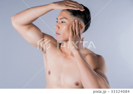 a portrait of handsome naked man touching his face a portrait of handsome naked man touching his face 33324084