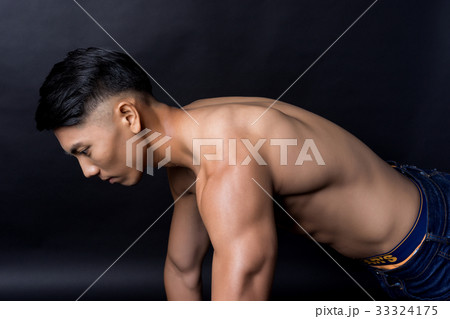 The picture of a naked man doing exercise on black background 33324175