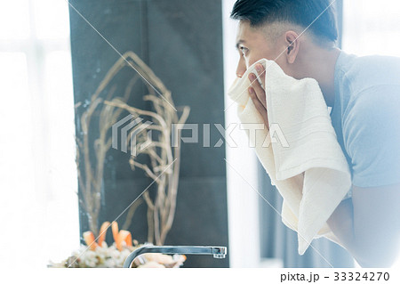 a photo of a man cleaning his face 33324270
