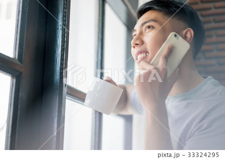 a photo of a man smiling and talking on the phone 33324295