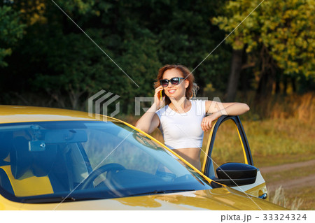 Girl is talking on phone by car 33324324
