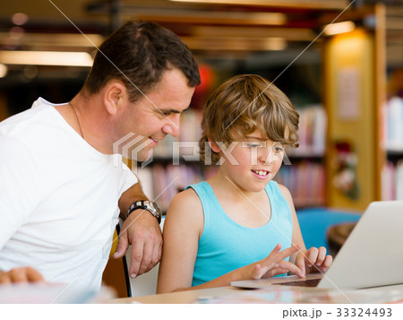 Little boy and his father with laptop Little boy and his father with laptop 33324493