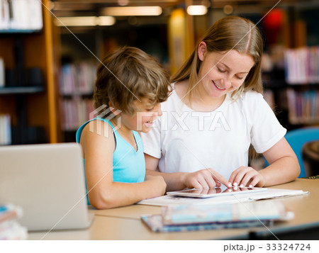 Teenage girl and her brother with books Teenage girl and her brother with books 33324724