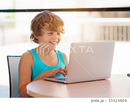 Little boy with laptop 33324809