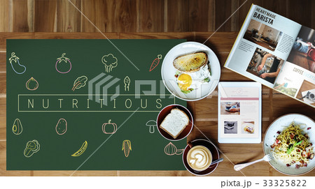 Breakfast meal on a wooden table and blackboard with vegetable icon 33325822