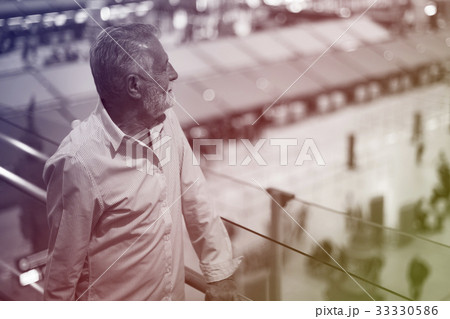 Man staring at the airport crowd downstairs Man staring at the airport crowd downstairs 33330586
