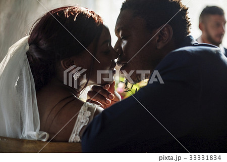 Newlywed African Descent Bride Kissing Groom Wedding Celebration 33331834