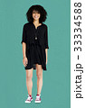 Woman standing smiling studio portrait 33334588