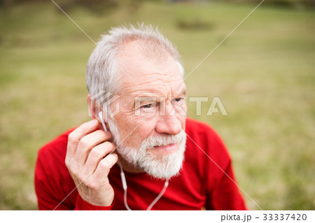 Active senior runner in nature with smart phone 33337420
