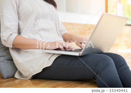 Young woman sitting on floor with laptop in library, education a Young woman sitting on floor with laptop in library, education a 33340441
