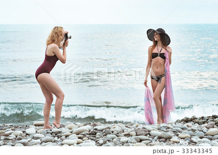Two young girls in bathing suits are photographed 33343345