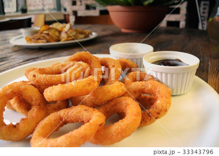 Fried Onion Rings and sauces on wooden table Fried Onion Rings and sauces on wooden table 33343796