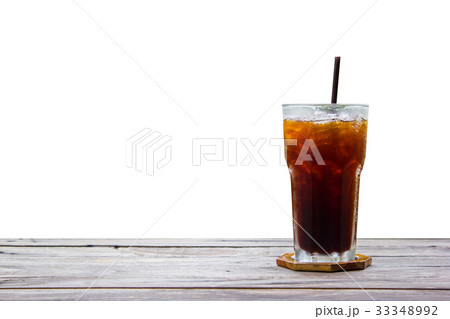 Americano in glass on wood plate and table 33348992