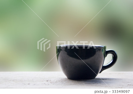 Black cup of coffee or tea on table 33349097