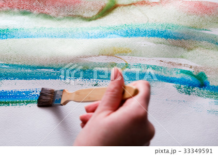 Brush in hands. Artist creating watercolor Brush in hands. Artist creating watercolor 33349591