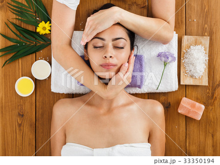 Woman massagist make face lifting massage in spa 33350194