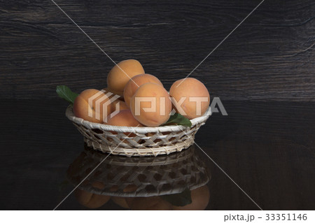 Apricots in bowl on a dark background 33351146