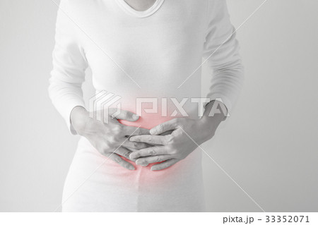 Woman stomachache on gray wall background. Woman stomachache on gray wall background. 33352071