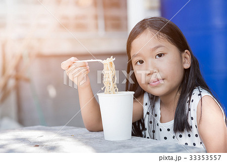 cute asian kid girl eating instand noodle cup, 33353557
