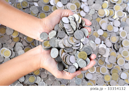 a lot of coins in hands 33354132