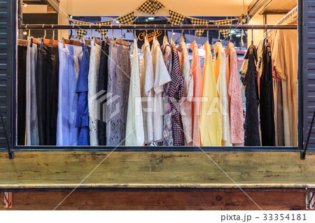 female clothes on open cloth rail wooden hanger 33354181