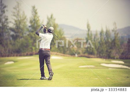 Golfers hit sweeping golf course in the summer 33354883
