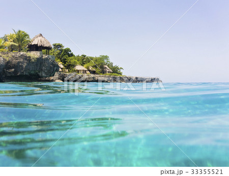 Jamaica, Negril, Traditional huts on rocky coastline 33355521