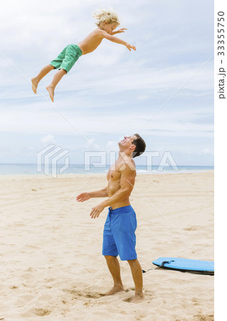 Father with son (4-5) playing at beach Father with son (4-5) playing at beach 33355750