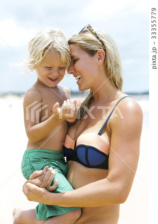 Mother with son (4-5) embracing at beach Mother with son (4-5) embracing at beach 33355779
