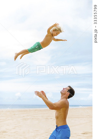 Father with son (4-5) playing at beach 33355799