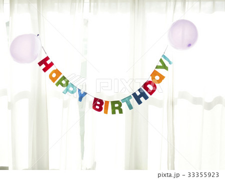 Birthday garland hanging in front of net curtain Birthday garland hanging in front of net curtain 33355923