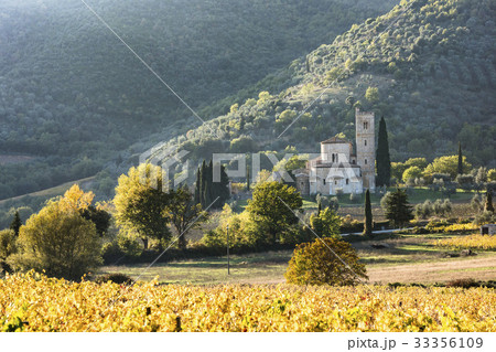 Italy, Tuscany, Montalcino, Abbey of Sant'Antimo near Montalcino against green hills 33356109