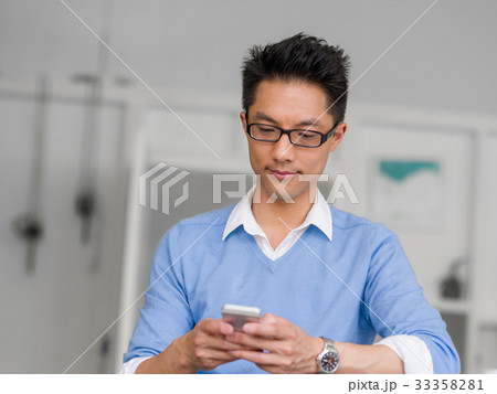 Portrait of young businessman with mobile 33358281