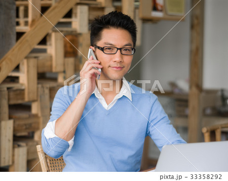 Portrait of young businessman with mobile 33358292