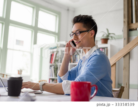 Portrait of young businessman with mobile 33358539