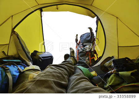 Traveler lying down in the tent Traveler lying down in the tent 33358899